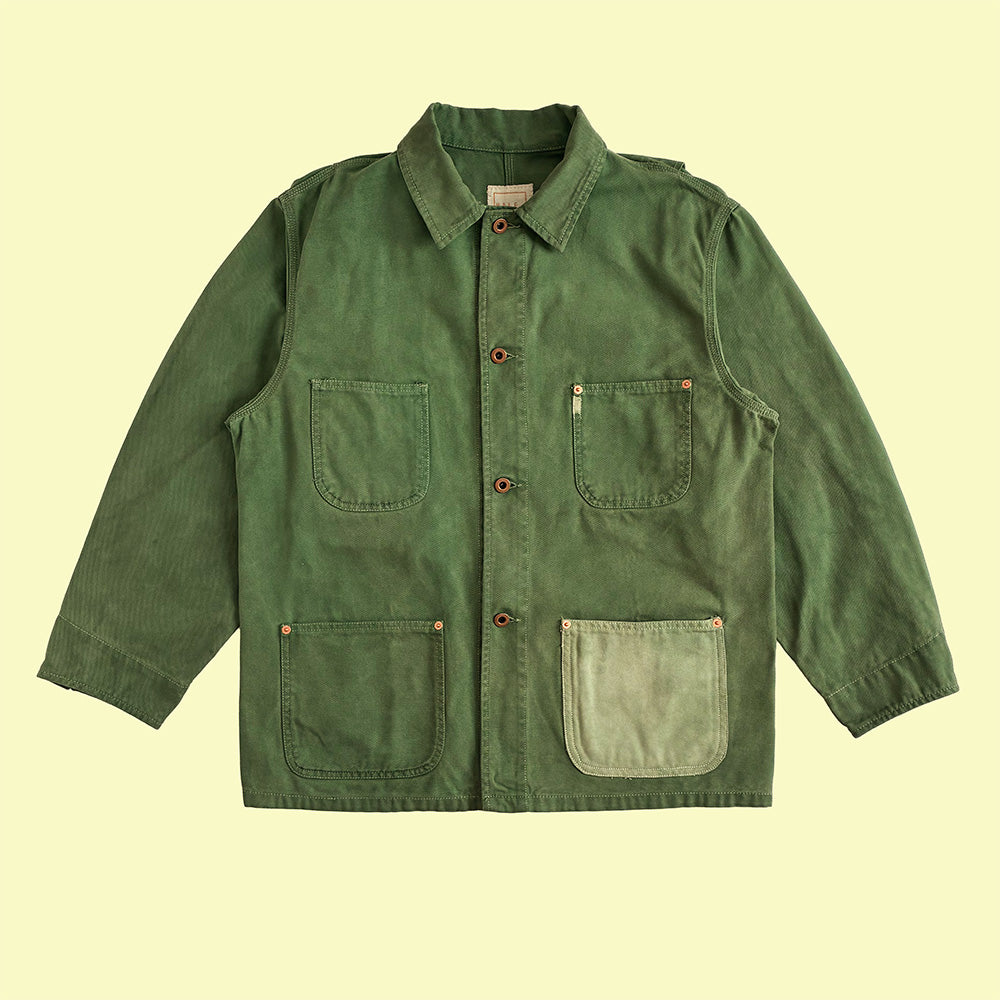 A green farmers utility jacket with four front pockets and copper donut buttons.